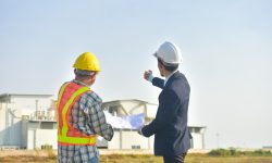 man-working-with-umbrella-standing-against-sky_1048944-7663013